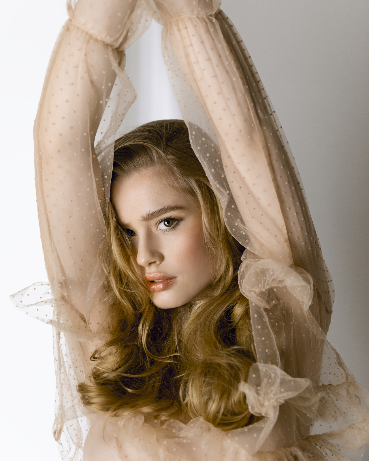 Make-up Fashionshooting fluffy brows Model mit sanften Wellen und zartem Make up in nudefarbener Transporter Bluse